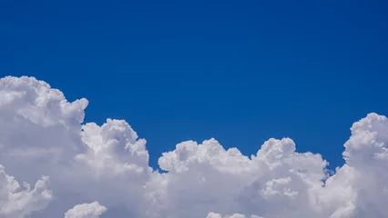 Beautiful summer blue sky background with white cumulonimbus clouds in sunny day © Prapat