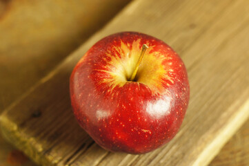Red ripe apple on a wooden table