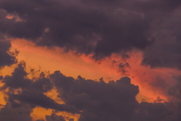 Sunset sky orange color with dark clouds background nature in the evening weather