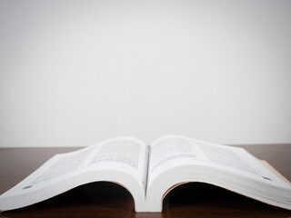 Text book open page on the table copy space