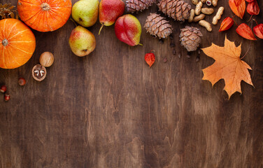 Wooden background with a frame of seasonal vegetables and fruits, autumn, copy space
