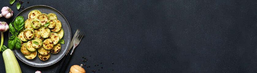 Grilled zucchini with sauce and garlic, top view