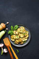 Grilled zucchini with sauce and garlic, top view