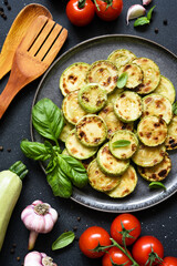 Grilled zucchini with sauce and garlic, top view