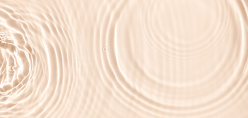 water texture ripples wave clean transparent water abstract background in beige color