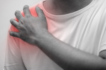man left shoulder pain hand touching pain area