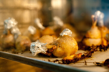 Cook preparing chicken confit leg.