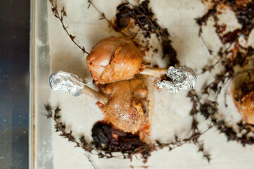 Cook preparing chicken confit leg.