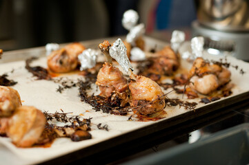 Cook preparing chicken confit leg.