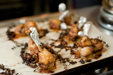 Cook preparing chicken confit leg.