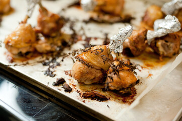 Cook preparing chicken confit leg.