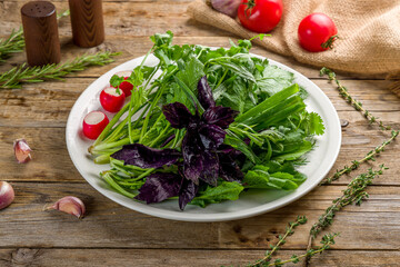 assorted greens on old wooden table side view