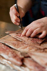 The cook separates the fillet from the fish and clears it from the bones. Mackerel fillets.
