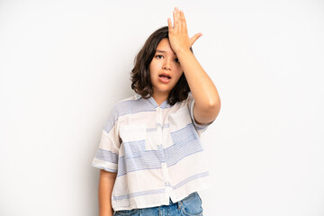 hispanic pretty woman raising palm to forehead thinking oops, after making a stupid mistake or...