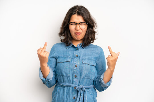 hispanic pretty woman feeling provocative, aggressive and obscene, flipping the middle finger, with a rebellious attitude