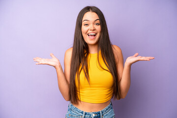 hispanic pretty woman feeling happy, excited, surprised or shocked, smiling and astonished at...