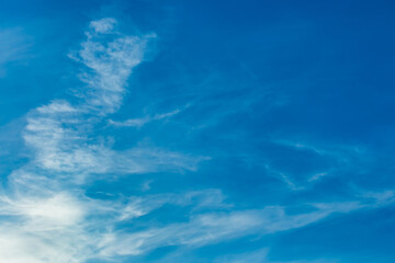 White cirrus clouds weather change wind natural background against the blue sky