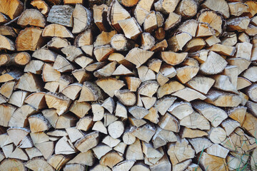 Chopped firewood piled up. Woodcutter. Wooden background, wallpaper.