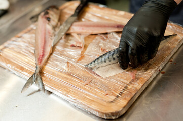 The cook separates the fillet from the fish and clears it from the bones. Mackerel fillets.