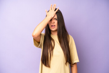 hispanic pretty woman raising palm to forehead thinking oops, after making a stupid mistake or...