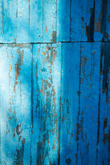 texture of old wooden boards with old cracked blue oil paint
