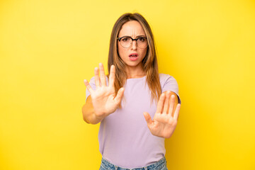pretty young adult woman feeling terrified, backing off and screaming in horror and panic, reacting...