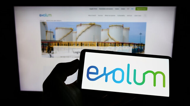 Stuttgart, Germany - 07-24-2022: Person holding cellphone with logo of Spanish energy company Exolum Group on screen in front of business webpage. Focus on phone display.