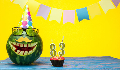 Funny watermelon in festive garlands for happy birthday greetings funny. Copy space watermelon with...