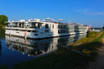 Two cruise liners docked besides each other at the banks of river Rhine (Breisach, Baden, Germany)