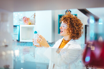 A female scientist examines samples in a laboratory, full of, state of the art research equipment. The NMR apparatus is discovering diseases such as autism, diabetes, dementia and cancer.  - obrazy, fototapety, plakaty