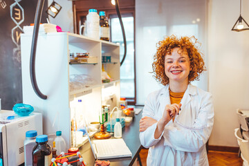 Shot of a female scientist working in a lab. Close-up of serious laboratory worker holding ampoule...