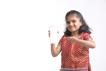 Cute indian little girl showing smartphone on white background