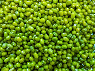 Wet green mung beans are scattered, close-up. Healthy nutrition, vegetable protein, animal protein replacement, vegetarianism, nutrition