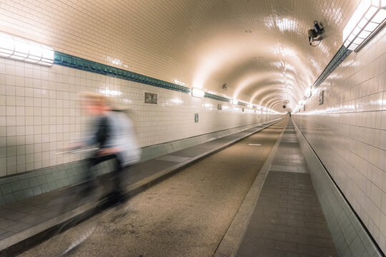 cyclist driving through the old elbtunnel in hamburg in the underground of the elb