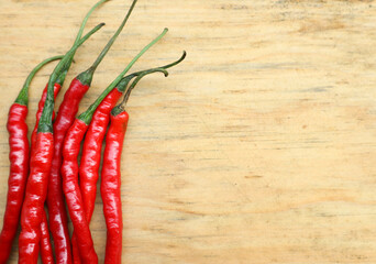 negative space, red cayenne pepper or cabai rawit merah on a wooden cutting board