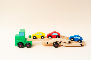Toy tow truck towing damaged cars after a serious accident. Car traffic, car crash, dangerous...