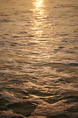 Sunlight and sea foam on the ocean surface