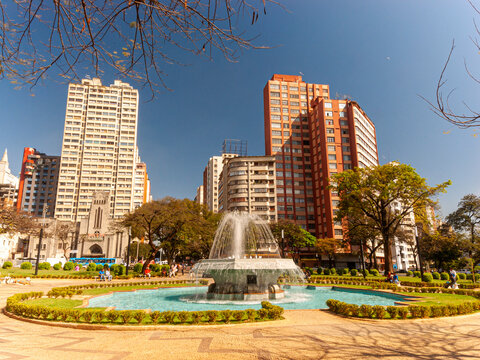 Central panorama of the city of Belo Horizonte. Raul Soares Square. Trees, fountain, blue sky and beautiful residential and commercial buildings.