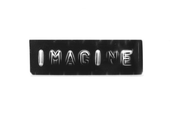 Black color banner that have embossed letter with word imagine on white paper background