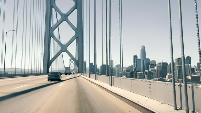 View through the windshield of a car driving over the Oakland Bay Bridge in San Francisco. View of Downtown San Francisco from the bridge.