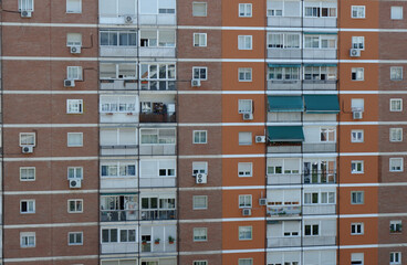 Facade of the residential building in the poor district of Madrid, Spain