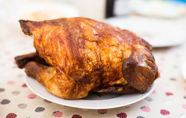 ruddy chicken fried whole on a plate on the festive table