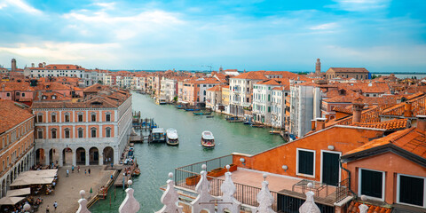Fototapeta na wymiar A panoramic view of Venice with red roofs and a turquoise canal.