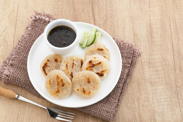 Pempek Tunu or Pempek Panggang, traditional food from South Sumatra, Indonesia. This fish-based food is very popular. Served with cuko sauce.
