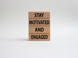 Stay Motivated and Engaged symbol. Concept words Stay Motivated and Engaged on wooden blocks. Beautiful white background. Business and Stay Motivated and Engaged concept. Copy space