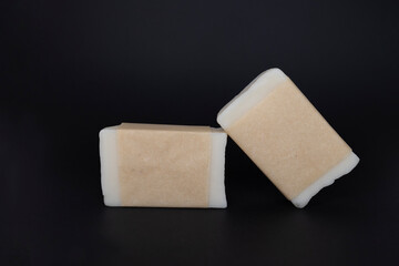 Handicraft soap for small business homemade natural organic soap on a black background. Kraft paper on a cosmetic product. Spa treatment. Concept: homemade craft soap from zero west