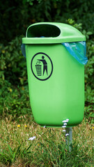 A public green trash can in Park in Germany