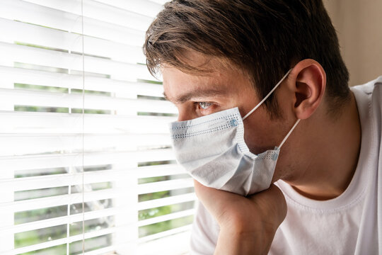 Sad Young Man in the Surgical Mask