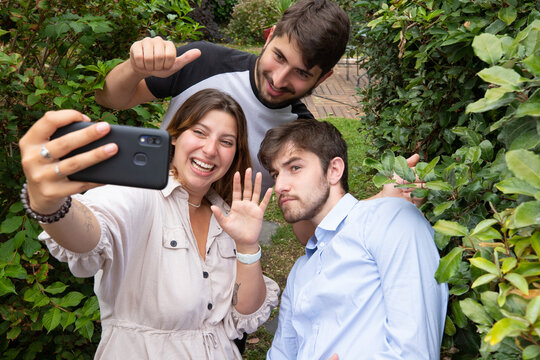 trois jeunes amis font un selfie avec un téléphone portable. Moment fun de complicité entre jeunes adultes