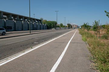 city: road, sidewalk and cycle path in perspective. mono skate in the distance on the bike path....